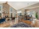 Spacious living room with a stone fireplace, hardwood floors, and large windows offering scenic views at 846 Circle K Ranch Rd, Evergreen, CO 80439