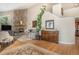 Cozy living room features a stone fireplace, hardwood floors, and comfortable seating for relaxing by the fire at 846 Circle K Ranch Rd, Evergreen, CO 80439