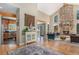Inviting living room featuring a stone fireplace, vaulted ceilings, and hardwood floors at 846 Circle K Ranch Rd, Evergreen, CO 80439