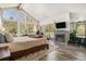 Comfortable main bedroom features a fireplace, access to a deck, and floor to ceiling windows with natural light at 846 Circle K Ranch Rd, Evergreen, CO 80439