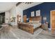 Main bedroom featuring a gorgeous dark blue accent wall, wood flooring, and ensuite with a glass-enclosed shower at 846 Circle K Ranch Rd, Evergreen, CO 80439