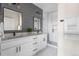Elegant bathroom boasts double sinks, sleek black fixtures, modern vanity, and a glass-enclosed shower at 1305 Osceola St, Denver, CO 80204