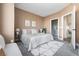 Neutral bedroom featuring a comfortable bed, stylish lamps, and access to the bathroom, creating a cozy retreat at 1305 Osceola St, Denver, CO 80204