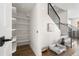 Hallway with staircase, open shelving, and a dog bed at 1305 Osceola St, Denver, CO 80204