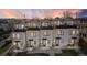 Row of modern townhomes with clean lines and a view of mountains at sunset at 1305 Osceola St, Denver, CO 80204