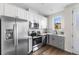 Modern kitchen features stainless steel appliances, gray cabinets, and wood floor at 1305 Osceola St, Denver, CO 80204