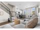 Open concept living space featuring a comfortable sofa, staircase, and kitchen area at 1305 Osceola St, Denver, CO 80204