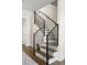 Modern staircase features wood treads, white risers, and sleek black metal railings, combining elegance with contemporary design at 1305 Osceola St, Denver, CO 80204