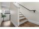 Elegant staircase featuring wooden steps and a sleek black handrail, seamlessly blending modern design with classic comfort at 1305 Osceola St, Denver, CO 80204