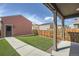 A nice backyard with artificial grass, patio, and tall wooden fence at 12770 Tamarac St, Thornton, CO 80602