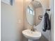 Bathroom features a pedestal sink, neutral decor, and modern fixtures at 12770 Tamarac St, Thornton, CO 80602