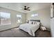 Cozy bedroom featuring large windows, plush carpet, and modern decor at 12770 Tamarac St, Thornton, CO 80602