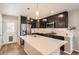 Contemporary kitchen with stainless appliances, shaker cabinets, and a large island with quartz countertop at 12770 Tamarac St, Thornton, CO 80602