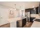Modern kitchen with stainless steel appliances, quartz countertop island, and white subway tile backsplash at 12770 Tamarac St, Thornton, CO 80602