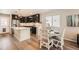 Stylish kitchen with a bright breakfast nook, featuring stainless steel appliances and dark wood cabinetry at 12770 Tamarac St, Thornton, CO 80602
