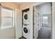 Stackable washer and dryer with white doors lead to another room at 12770 Tamarac St, Thornton, CO 80602