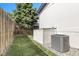 Backyard with grassy area, gravel, and air conditioning unit at 8497 Madison Way, Denver, CO 80229