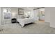 Bright bedroom featuring plush carpeting, modern decor, and a sliding barn door to the ensuite bathroom at 8497 Madison Way, Denver, CO 80229
