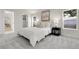 Cozy bedroom with neutral decor, plush carpet, a large window, and a glimpse into the spacious closet at 8497 Madison Way, Denver, CO 80229