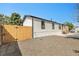 Home exterior with gravel yard and partial wooden fence at 8497 Madison Way, Denver, CO 80229