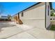 Side view of a charming single-story home with new concrete driveway and newly painted siding at 8497 Madison Way, Denver, CO 80229