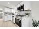 Modern kitchen featuring stainless steel appliances, white cabinetry, and stylish hardware at 8497 Madison Way, Denver, CO 80229