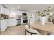 Bright kitchen with white cabinets, stainless steel appliances, and a stylish tile backsplash at 8497 Madison Way, Denver, CO 80229