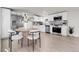 Modern kitchen with stainless steel appliances, white cabinets, and elegant dining area at 8497 Madison Way, Denver, CO 80229