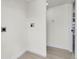 Bright laundry room featuring utility hookups, wood look flooring, and a storage area at 8497 Madison Way, Denver, CO 80229