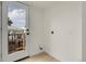 Bright laundry room with wood-look flooring and door to outside area at 8497 Madison Way, Denver, CO 80229