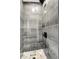 Modern tiled shower featuring sleek fixtures and a mosaic tile floor at 8497 Madison Way, Denver, CO 80229