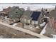 Aerial view of cozy backyard with a patio, solar panels, and a white picket fence at 11060 River Oaks Ln, Commerce City, CO 80640