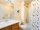 Full bathroom with a shower-tub combo, dinosaur themed shower curtain, and a modern vanity at 11060 River Oaks Ln, Commerce City, CO 80640