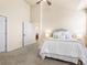 Bedroom with neutral decor and view to dining room; plush carpeting at 11060 River Oaks Ln, Commerce City, CO 80640