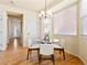 Bright dining area featuring modern chandelier, hardwood floors, and large window at 11060 River Oaks Ln, Commerce City, CO 80640