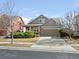 Charming two-story home with a driveway and a manicured front lawn at 11060 River Oaks Ln, Commerce City, CO 80640