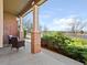 Charming front porch featuring brick columns and a comfortable seating area at 11060 River Oaks Ln, Commerce City, CO 80640