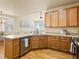 Modern kitchen featuring wooden cabinets, stainless steel appliances, and hardwood floors at 11060 River Oaks Ln, Commerce City, CO 80640
