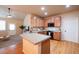 Modern kitchen featuring hardwood floors, updated cabinets, and a tiled island at 11060 River Oaks Ln, Commerce City, CO 80640