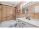 Bathroom featuring a tub, white vanity, updated fixtures, and neutral tile at 765 S Alton Way # 6B, Denver, CO 80247