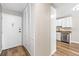 Entryway with wood floors, closet, and a view into the kitchen with updated appliances at 765 S Alton Way # 6B, Denver, CO 80247