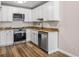 Modern kitchen with stainless steel appliances, sleek white cabinets, and granite counters at 765 S Alton Way # 6B, Denver, CO 80247