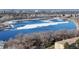 Beautiful aerial view of a large lake, mature trees, and the city skyline in the background at 765 S Alton Way # 6B, Denver, CO 80247
