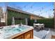 Backyard features hot tub, patio set, bistro lights, and privacy landscaping at 4170 Vrain St, Denver, CO 80212