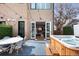 Private backyard featuring a hot tub, outdoor seating, stylish pavers, and inviting ambiance with string lights at 4170 Vrain St, Denver, CO 80212