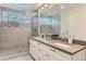 Spacious bathroom features dual sinks, large vanity, and frameless shower at 4170 Vrain St, Denver, CO 80212