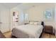 Cozy bedroom boasts hardwood floors and a view of the ensuite bath at 4170 Vrain St, Denver, CO 80212