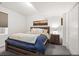 Cozy bedroom featuring a comfortable bed, a nightstand, and a window with natural light at 4170 Vrain St, Denver, CO 80212