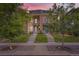 Inviting townhome featuring meticulous landscaping and modern architectural details, set against a vibrant sunset sky at 4170 Vrain St, Denver, CO 80212