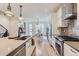 Open kitchen with island and bar seating, flowing seamlessly into the dining area, full of natural light at 4170 Vrain St, Denver, CO 80212